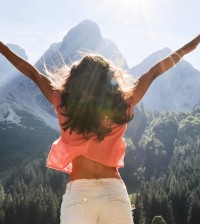 Girl joy freedom Austria mountain forest trees lake height view view sky clouds sun light rays